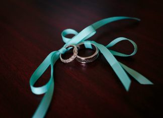 Engagement Rings & Wedding Rings : bride and groom's wedding bands tied with pretty turquoise bows…