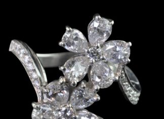 Diamond Rings : Beautiful diamond-set ring designed as a double-flowerhead cross-over with taper…