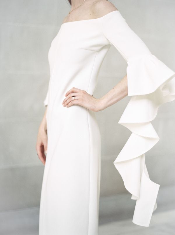 Chic ruffle sleeve sheath wedding dress: www.stylemepretty... Photography: Taral...