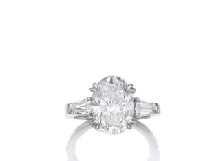 Diamond Rings : Diamond ring Set with an oval diamond weighing 5.02 carats, between tapered bagu…