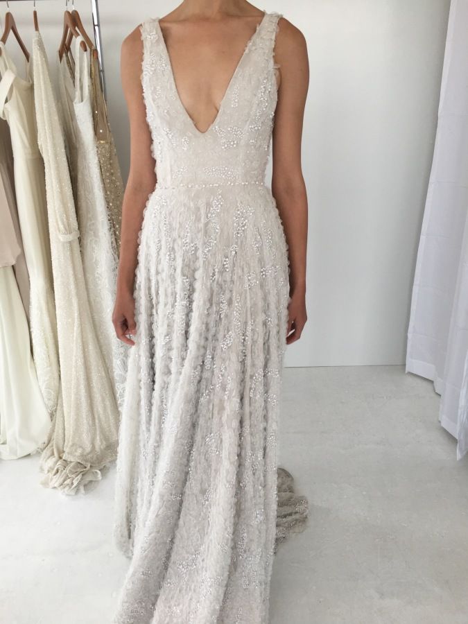 Ivory embellished plunging neckline wedding dress: www.stylemepretty... Photogra...